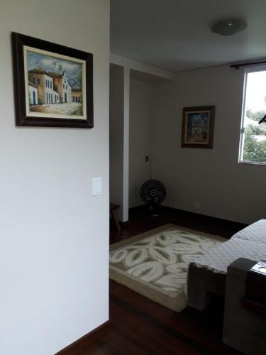 a bedroom with a bed and a picture on the wall at Casa da Praia in Itajaí