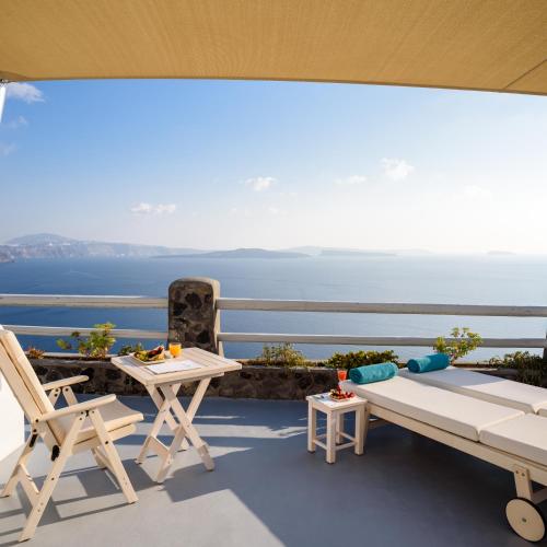 a balcony with a view of the ocean at Thirea Suites in Oia