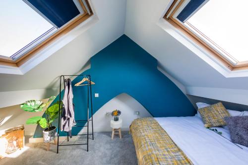 - une chambre avec un mur bleu et un lit dans l'établissement The Hollywood - Beautiful 3 Bedroom House, à Cardiff