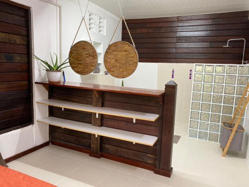 a room with wooden shelving and three baskets at Le Goyav' appart avec piscine et jacuzzi au Vauclin in Le Vauclin