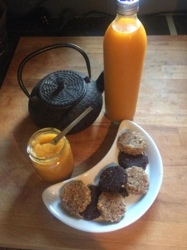 a plate of donuts and a plate of orange juice at Celine'Home in Saint-Germain-sur-Morin