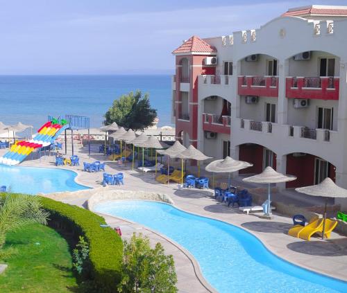 a view of a resort with a swimming pool and the ocean at La Sirena Hotel & Resort - Families only in Ain Sokhna