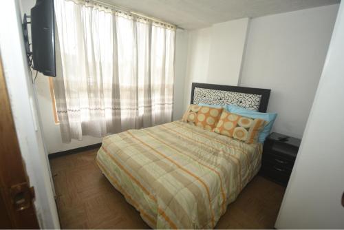 A bed or beds in a room at APARTAHOTEL CALLE 80 Bogota por SEMANAS