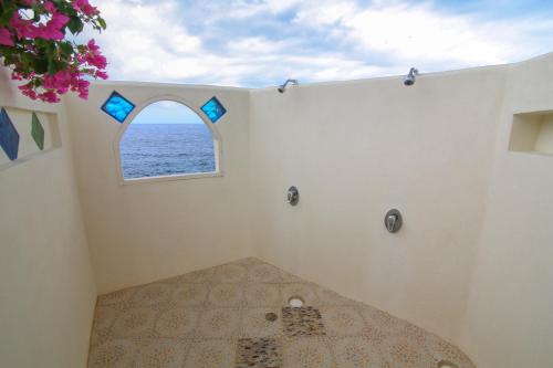 a bathroom with an ocean view through a window at Catcha Falling Star in Negril