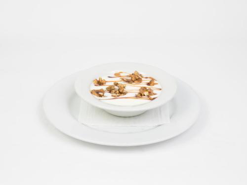 a bowl of hazelnuts on a white plate at Hotel Roma in Sarria