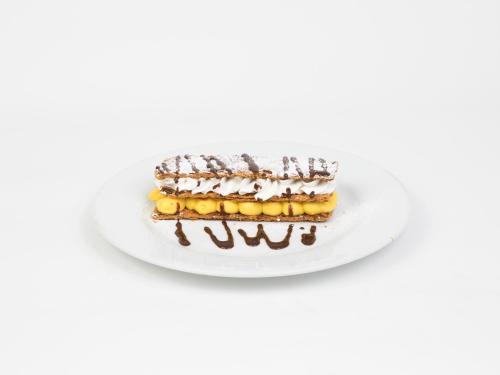 a piece of cake on a white plate at Hotel Roma in Sarria