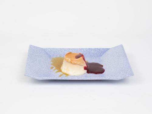 a piece of ice cream on a plate with sauce at Hotel Roma in Sarria