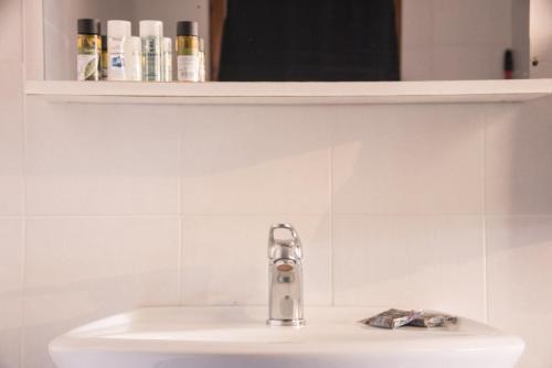 a bathroom sink with a faucet on top of it at Platanorema in Agios Ioannis Prodromos