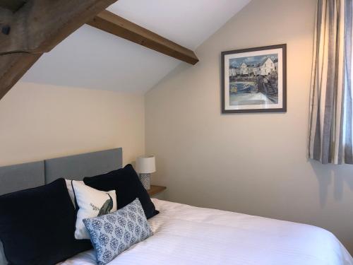 a bedroom with a bed and a picture on the wall at Little Coombe, Bookham Court in Dorchester
