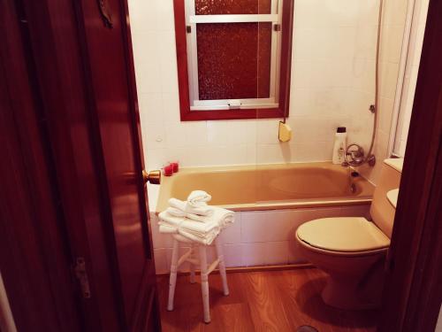a bathroom with a tub and a toilet and a sink at La Casina in Sevares