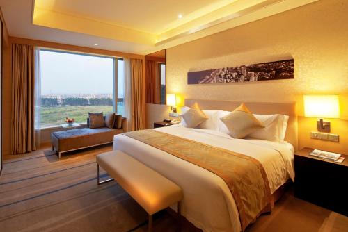 a hotel room with a large bed and a large window at Crowne Plaza Guangzhou Huadu by IHG - Free Shuttle bus between hotel to Exhibition Center During Canton Fair in Guangzhou