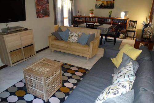 a living room with a couch and a table at AZURARA BEACH large and sunny apartment in Árvore