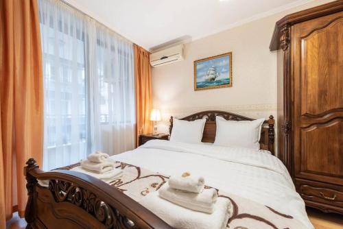 a bedroom with a bed with towels on it at Vazov Residence , two bedroom top centre apartment in Varna City