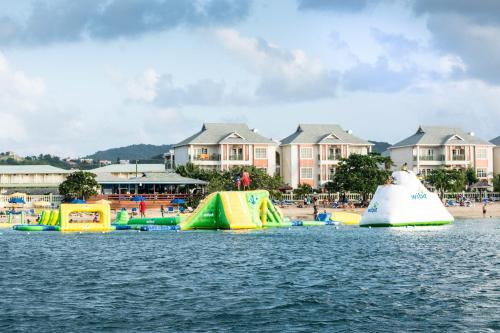 a group of inflatable slides in the water near a beach at The Harbour in Rodney Bay Village