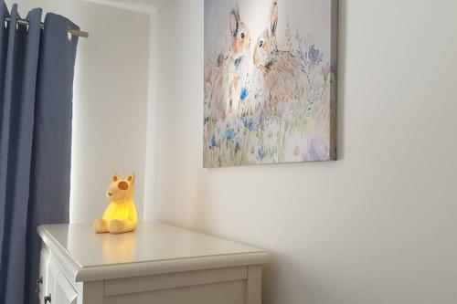 a toy cat sitting on top of a dresser in a room at Rutland View in Oakham