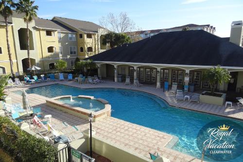 a pool at a hotel with chairs and a resort at Royal Dream at Avalon Clearwater - Pool & Free Parking - 10 Min Drive to Clearwater Beach in Clearwater Beach