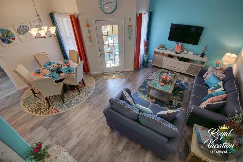 a living room with a couch and a dining room at Royal Dream at Avalon Clearwater - Pool & Free Parking - 10 Min Drive to Clearwater Beach in Clearwater Beach