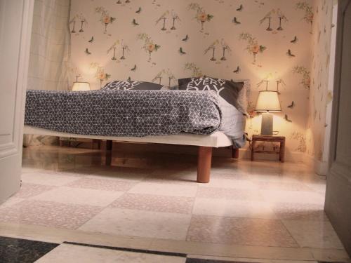 une chambre avec un lit et un sol carrelé dans l'établissement Maison Julien 3, à Menton