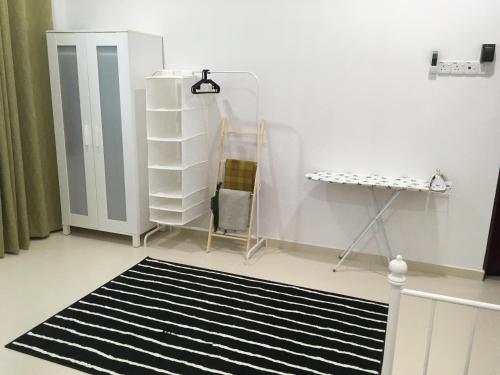 a room with a black and white rug and a shelf at Arwaa Homestay Beachview in Bachok