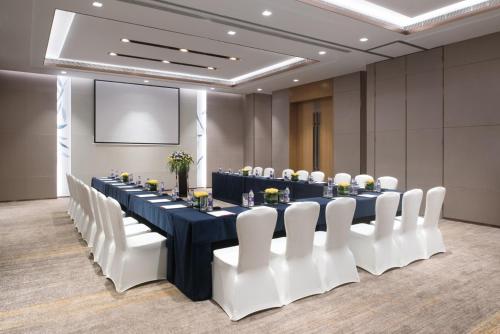 a conference room with a long table and white chairs at Crowne Plaza Hangzhou Qiantang - The subway can reach the West Lake scenic area as well as the airport and high-speed rail station, adjacent to Jinsha Lake and Longfor paradise walk in Hangzhou