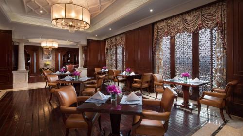 a restaurant with tables and chairs and a chandelier at Crowne Plaza Deqing Moganshan, an IHG Hotel in Deqing