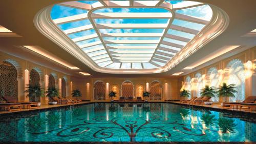 a large swimming pool in a building with a skylight at Crowne Plaza Deqing Moganshan, an IHG Hotel in Deqing