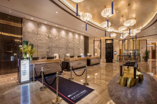 a lobby of a hotel with chandeliers at Crowne Plaza Hefei Rongqiao by IHG in Hefei