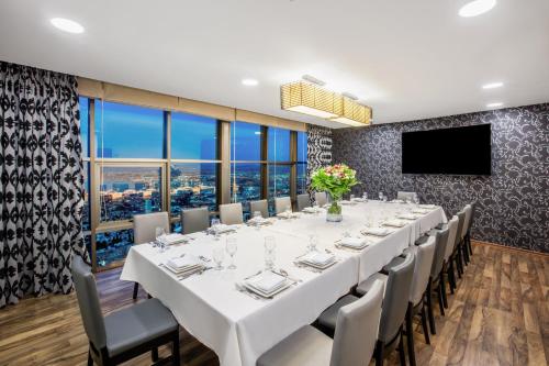 a conference room with a long table and chairs and a flat screen tv at Crowne Plaza Haifa by IHG in Haifa