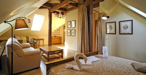 a bedroom with a bed and a living room at Hotel Kristin Hrádek in Děčín