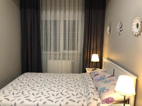 a bedroom with a bed and a window at Koza Apartment, next to Akbati Shopping Mall and Tennis court Soul Entertainment in Istanbul