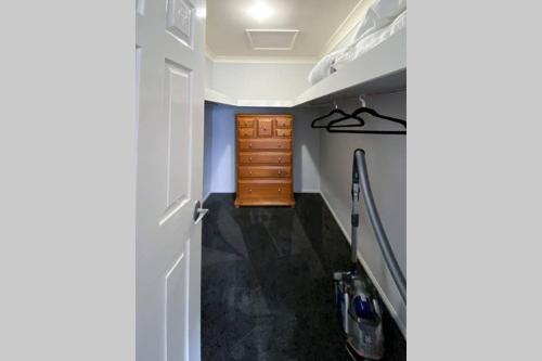 a room with a hallway with a door and a staircase at Executive and Family Home Large - Flinders View 24 in Ipswich