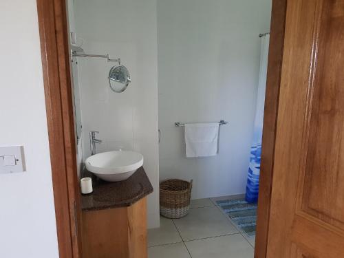 a white bathroom with a toilet and a sink at Chepsted Chalets in Glacis