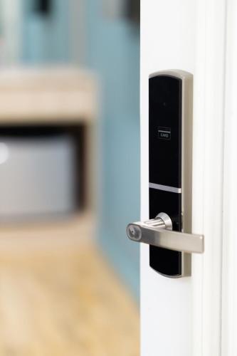 a lock on a door with a television in the background at Helen Fin Inn & Apartment in Phnom Penh