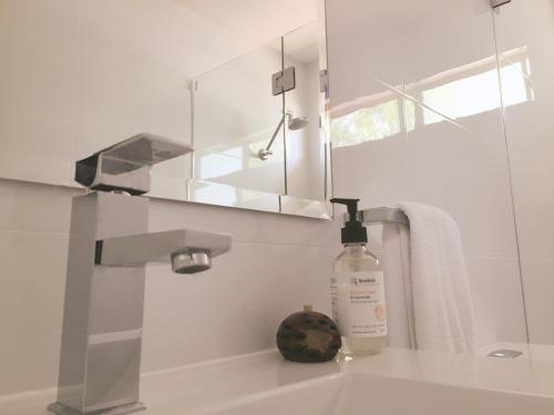 a bottle of soap sitting on a sink in a bathroom at Nepean by Gateway Lifestyle Holiday Parks in Penrith