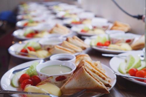 a table full of plates of food with sandwiches and fruit at TREE HOUSE in Pingtung County