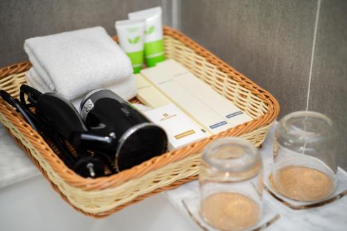 a wicker basket with towels and other items on a counter at Helen Fin Inn & Apartment in Phnom Penh
