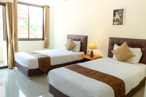 Кровать или кровати в номере Sasi Nonthaburi Hotel
