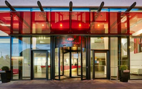 a store front with revolving glass doors in a building at Crowne Plaza Manchester City Centre by IHG in Manchester
