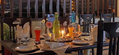 a table with glasses and a bottle of wine at Rudransh Inn by Trulyy in Jodhpur