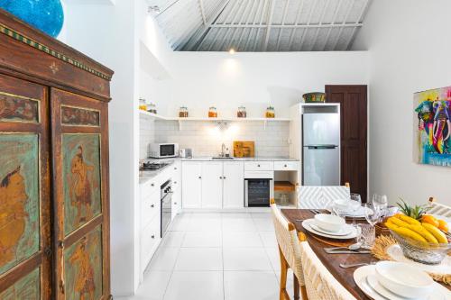 a kitchen with a table with plates on it at Villa Atma in Seminyak