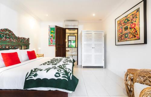 a bedroom with a king sized bed in a room at Villa Atma in Seminyak