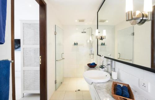a bathroom with a sink and a shower at Villa Atma in Seminyak