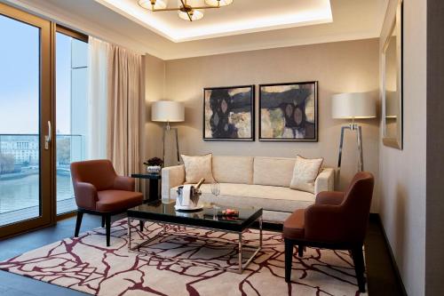 a living room with a couch and two chairs at Hyatt Regency London Albert Embankment in London