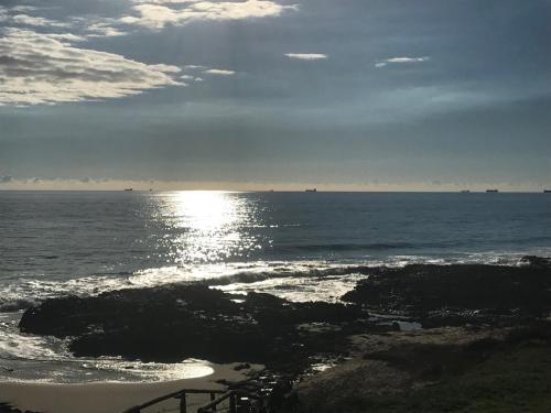 a view of the ocean with the sun reflecting on the water at The Beach Villa Bunbury in Bunbury