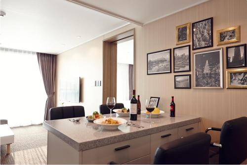 a room with a table with two glasses of wine at Royal Square Hotel Seoul in Seoul
