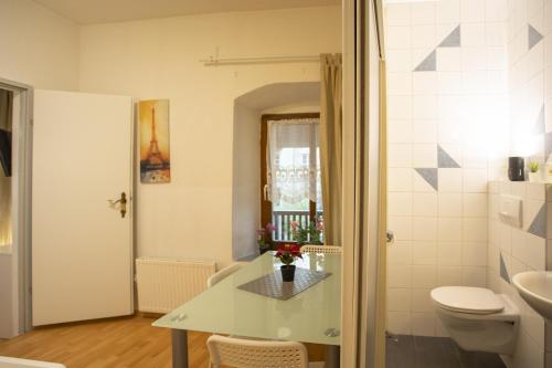 a bathroom with a white toilet and a sink at Nice Old Town Apartment in Hall in Tirol