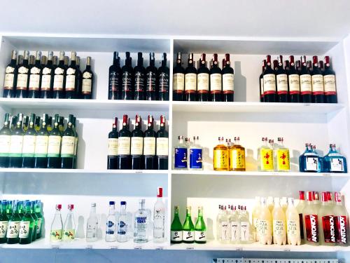 a refrigerator filled with lots of bottles of alcohol at Kim Oanh Orchids Hotel in Da Lat