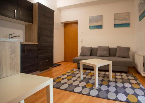 a living room with a couch and a table at Nice Old Town Apartment in Hall in Tirol