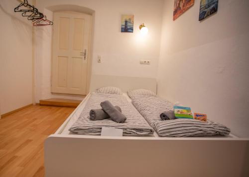 a white bed with pillows on it in a room at Nice Old Town Apartment in Hall in Tirol