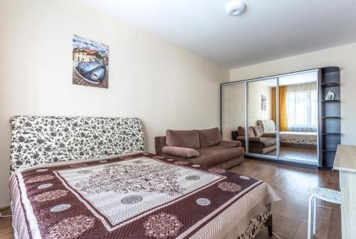 a bedroom with a large bed and a couch at #Go2SPB - STARS View Apartment SOFIA in Saint Petersburg